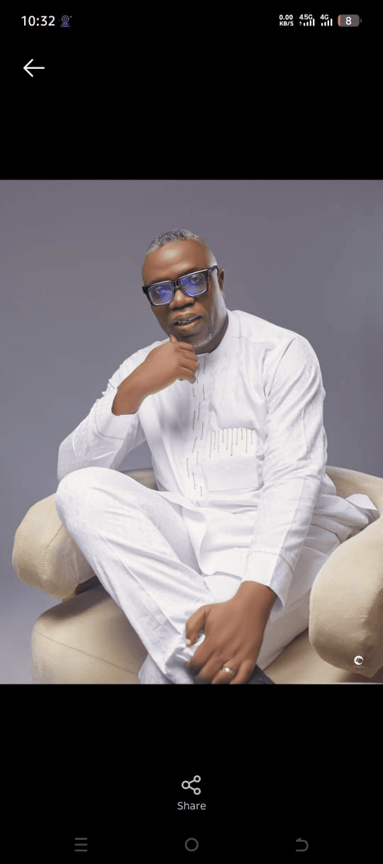 Pastor Ezeghare Kome seated in a white outfit